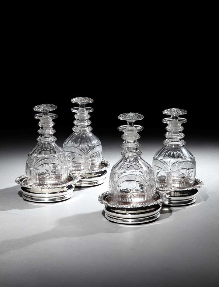 A PAIR OF REGENCY SILVER PLATE DOUBLE DECANTER COASTERS
